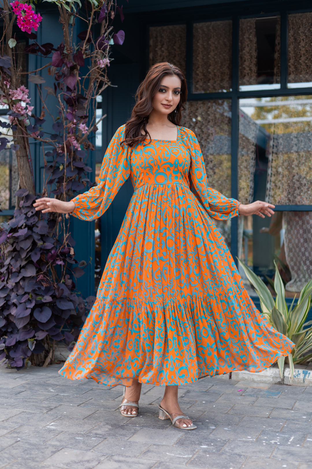 Model wearing Pop Drop orange and cyan blue floral maxi dress by Masakali