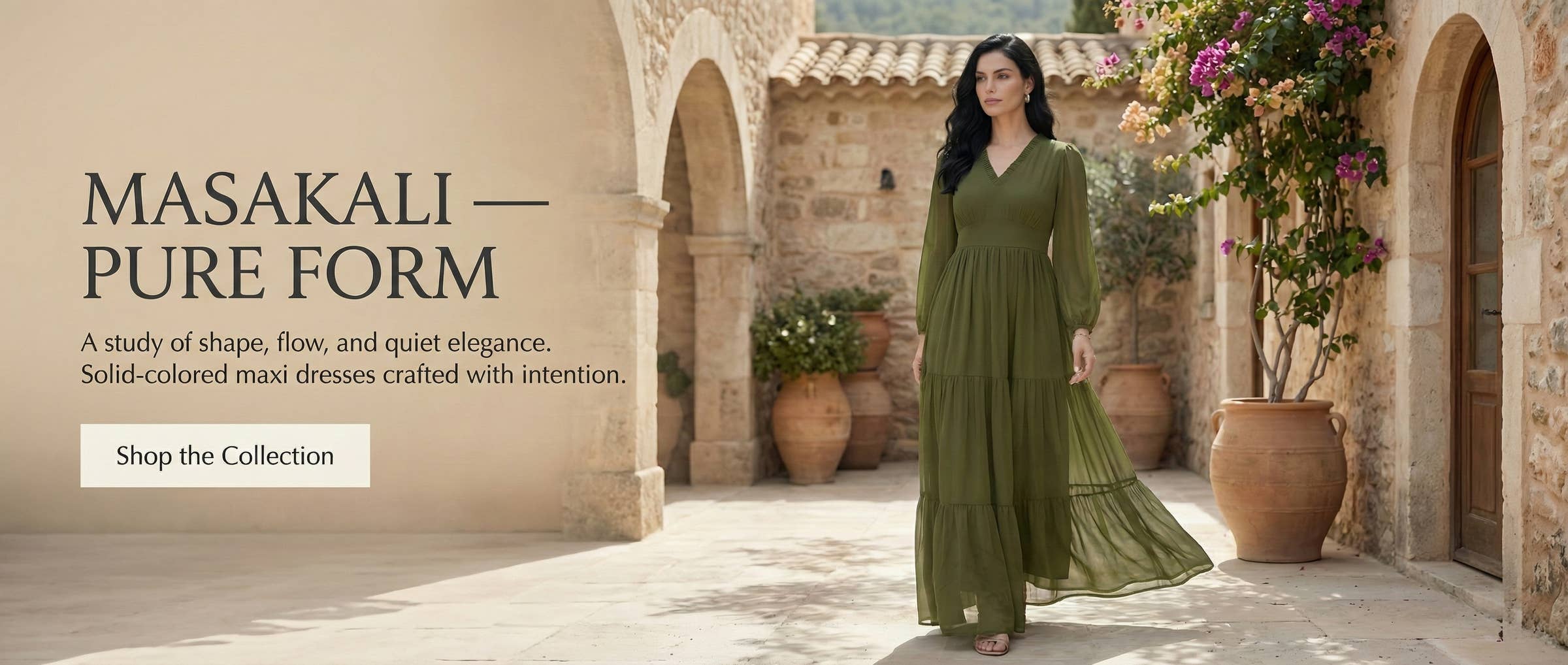 Woman in a green dress standing in an outdoor setting with arches and plants.