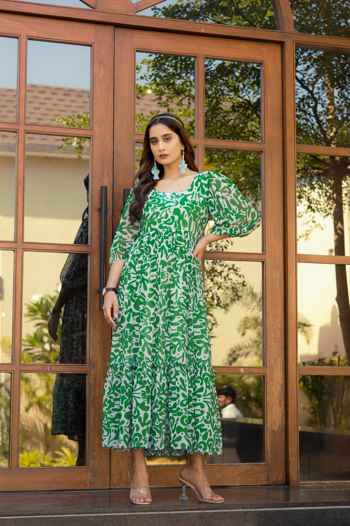 Full-length view of green floral maxi dress styled with silver accessories
