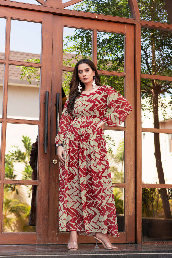 Full-length view of maroon and cream floral maxi dress styled with silver accessories
