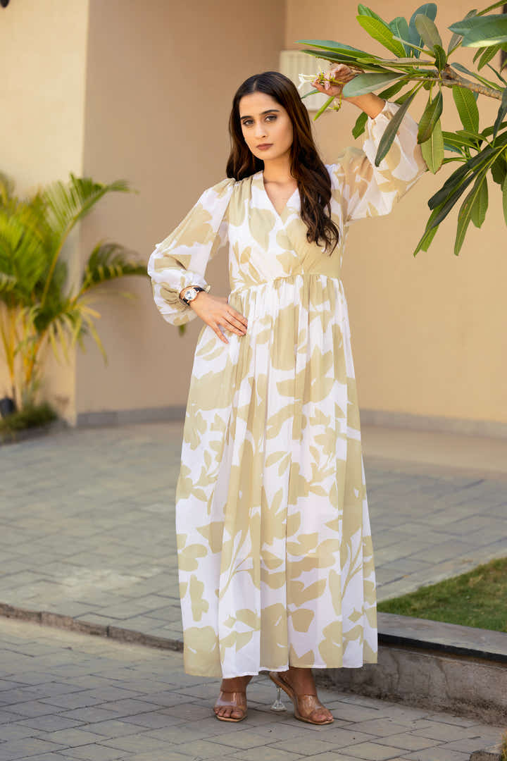 Full-length view of petal green & cream floral maxi dress styled with silver accessories