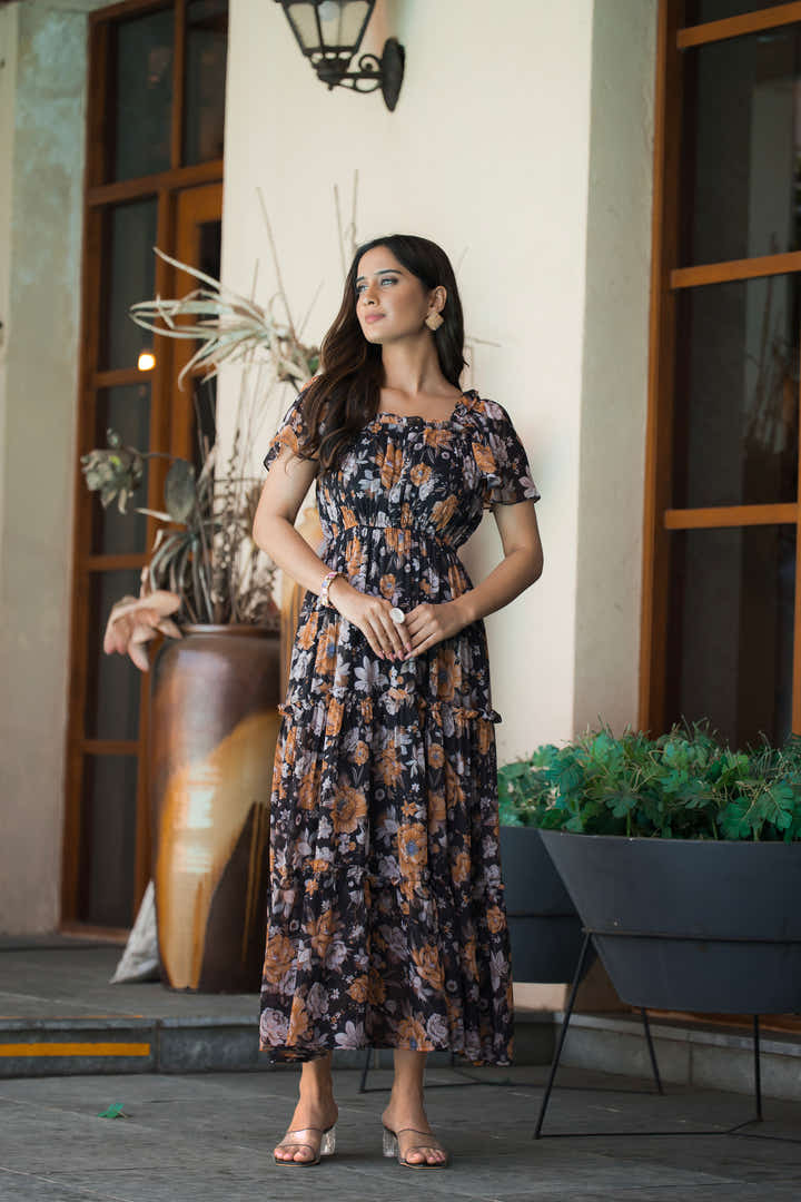 Full-length view of black midi dress styled with silver accessories