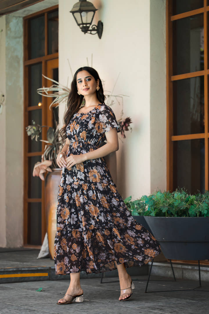 Full-length view of black midi dress styled with silver accessories