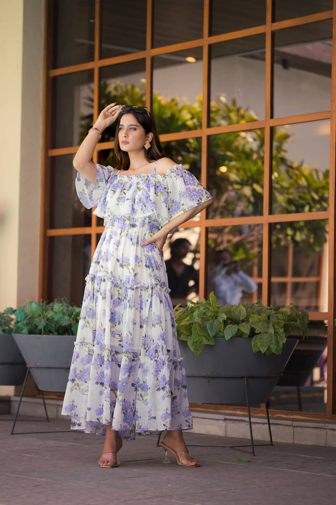 Full-length view of lavender floral dress styled with silver accessories