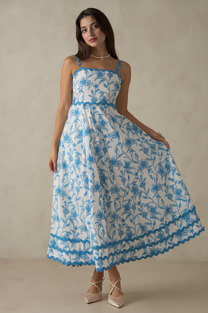 Woman wearing a blue floral dress against a beige background